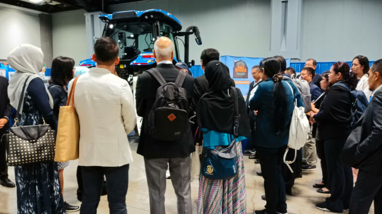 Group of ASCN delegates on the Expo floor examining new technology featured in the show